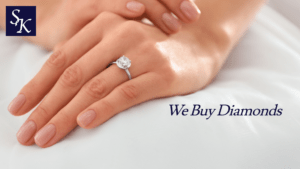 close up of left hand, large diamond engagement ring on ring finger